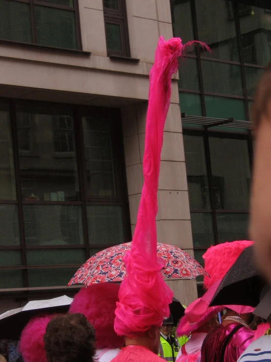 several people are walking down a street holding umbrellas