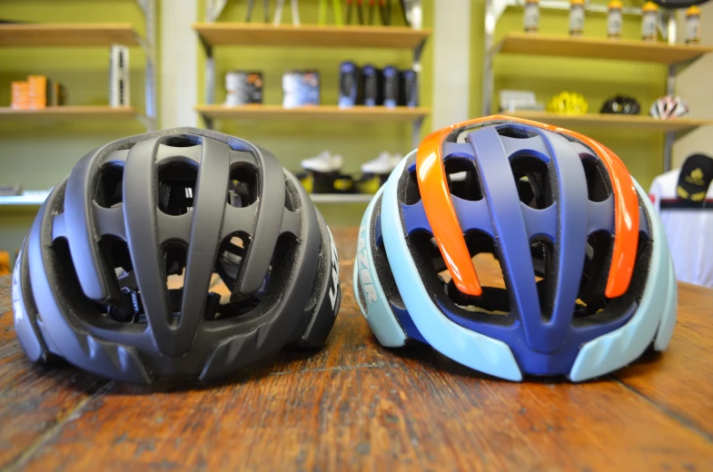two helmets that are on the counter and next to each other