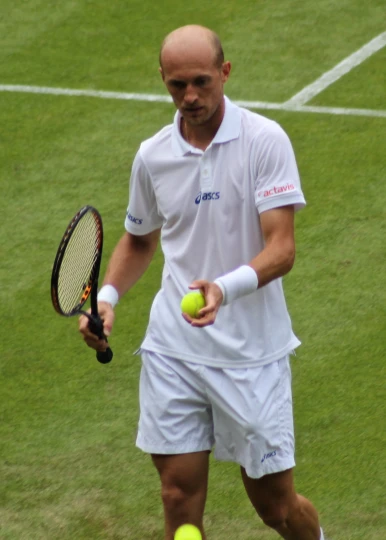 a man in white tennis outfit holding a racquet and tennis ball