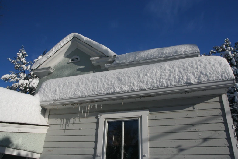 the window and the roof have been covered with snow