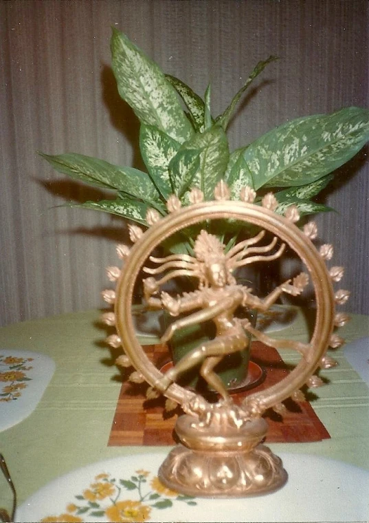 an intricately decorated golden statue with leaves