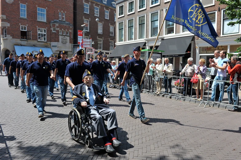 a crowd with a person in a motorized wheelchair