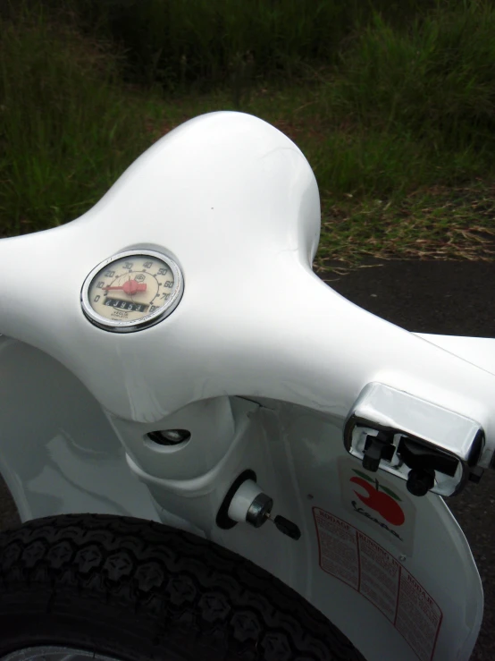 the ke hubs on a white motorcycle, while the front wheel rests