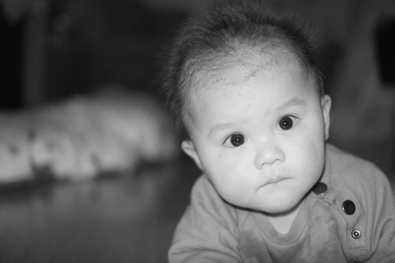 a black and white po of a baby with black eyes