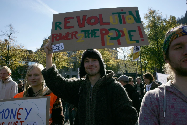 people holding signs on one side of the street