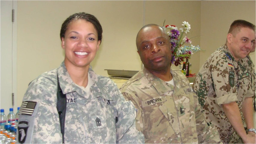 two men and a women in camouflage jackets