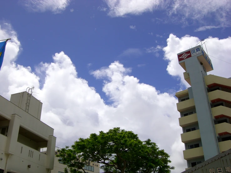 two buildings with flags flying in the air