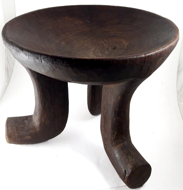 a wooden table with a curved foot