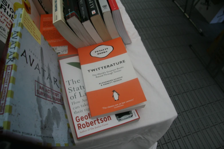 a book display at a local book fair in front of an advertit table