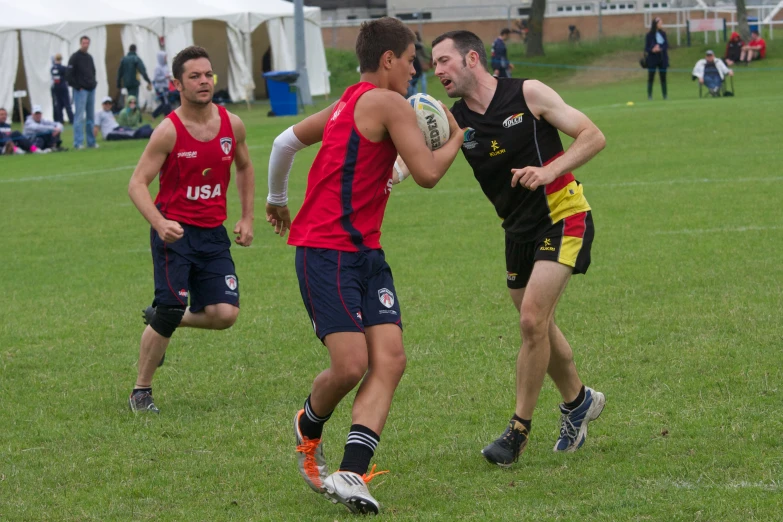 two men in uniforms running around with a ball