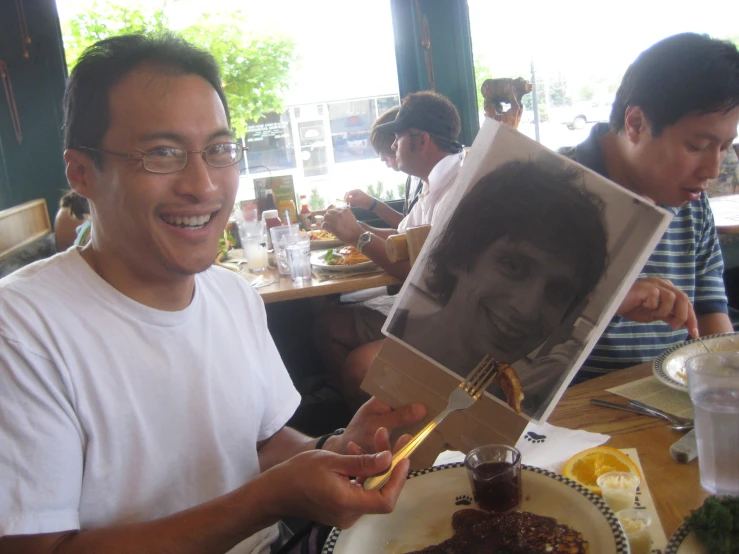 a man holding up a po to a cake on a plate