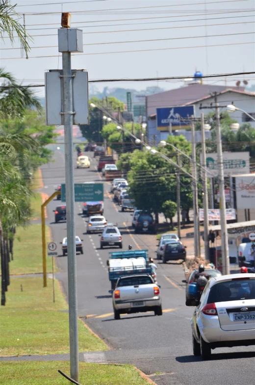 an empty city street with cars driving down the road