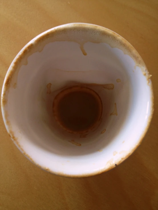 a white ceramic bowl with a brown spot on top