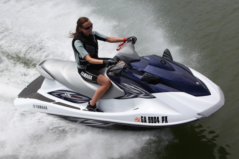 man driving a jet ski out of the water