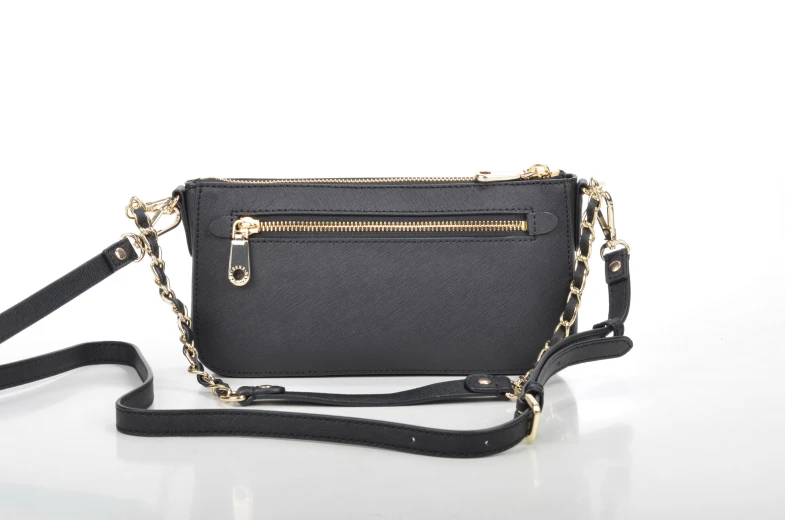 the cross - body purse is shown with its zipperped compartments