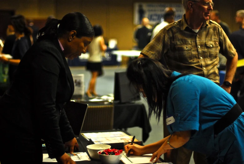 a group of people working on paperwork at an event