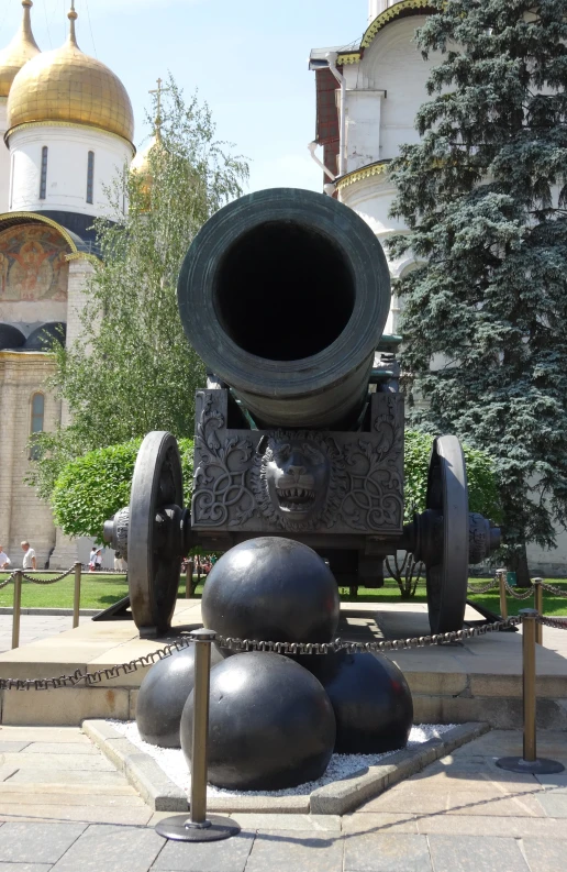 a statue of a cannon and other decorations in the background