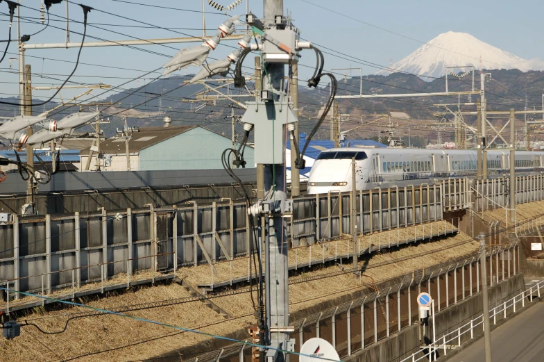 an overhead view of train with mountains in the background