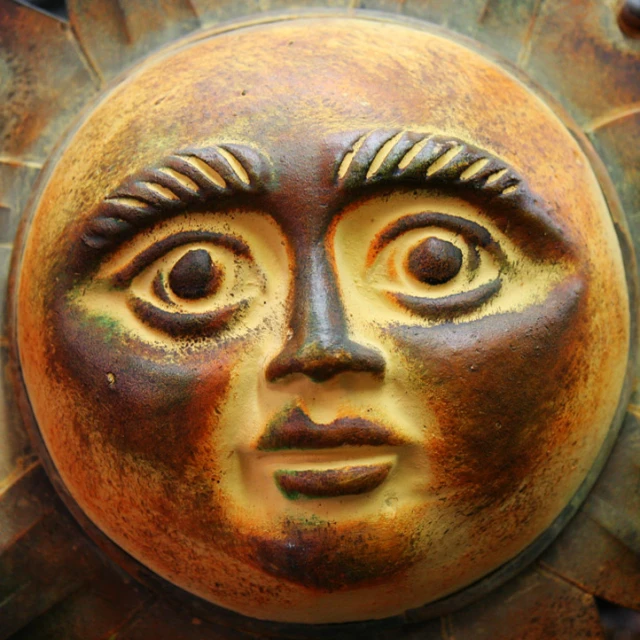 this is a decorative piece of art that looks like a sun face