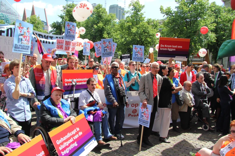 a crowd with signs in the street holding signs