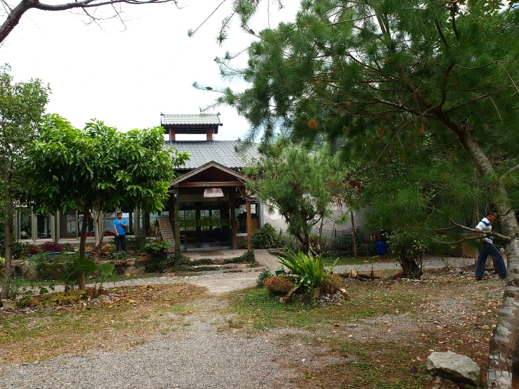 a man is using a lawn mower in a country yard