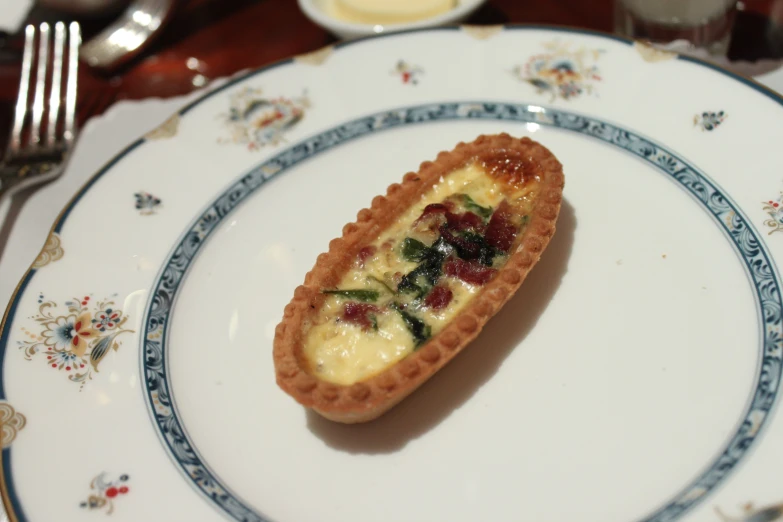 an embellished tart on a white plate with a blue border