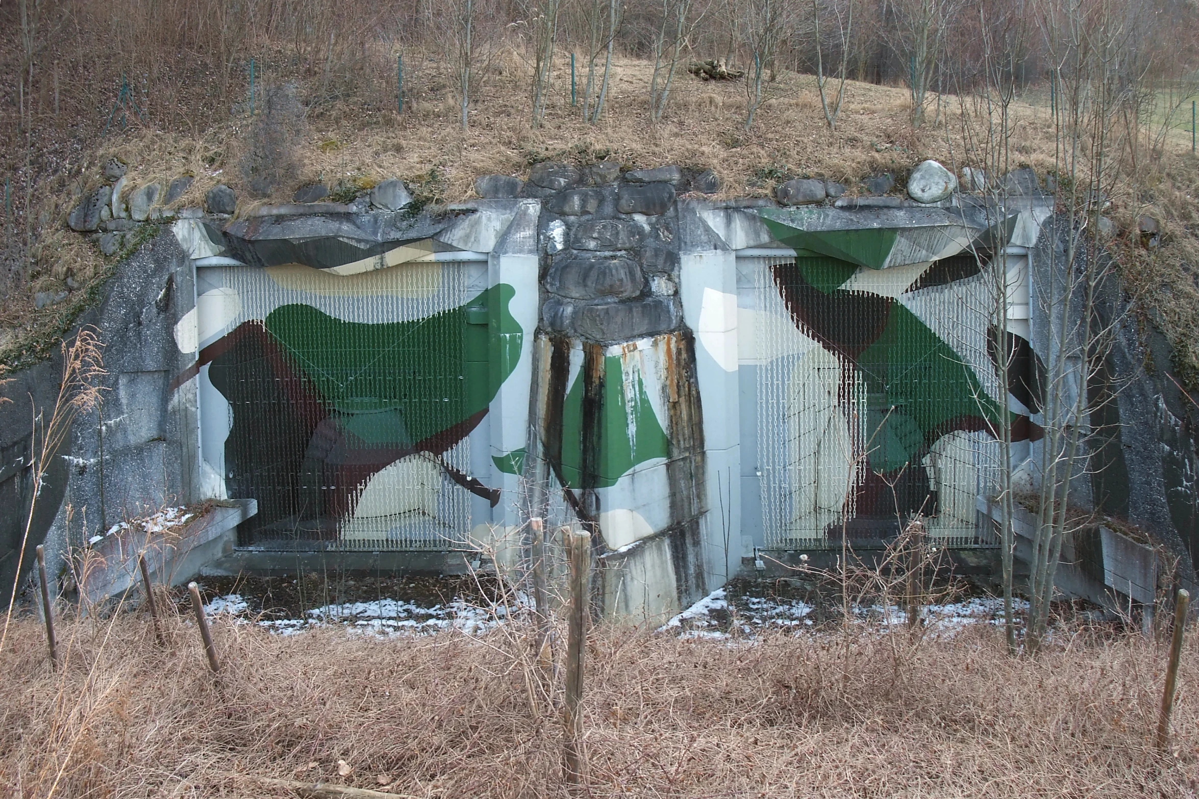 this is a broken fence with graffiti on it