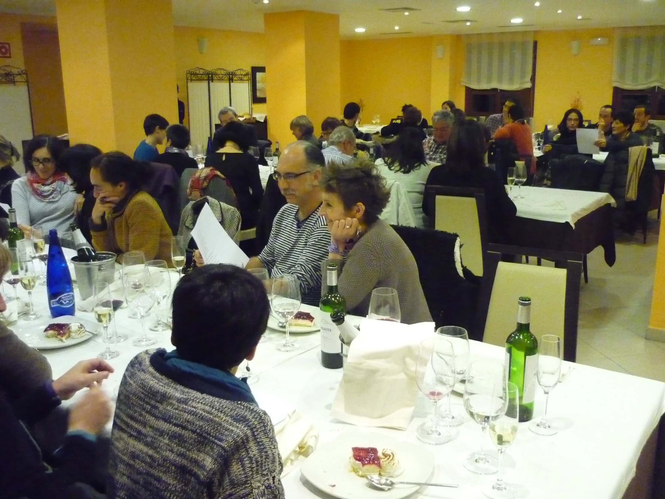 people are sitting at tables in a large restaurant