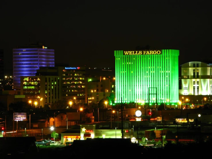 a view of a city at night with buildings lit up in the colors of the american flag