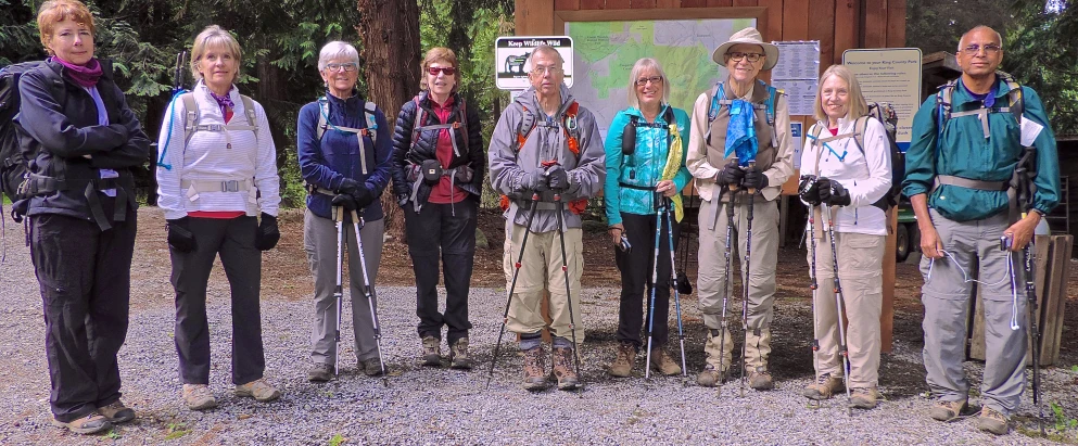 the group of people are standing next to each other