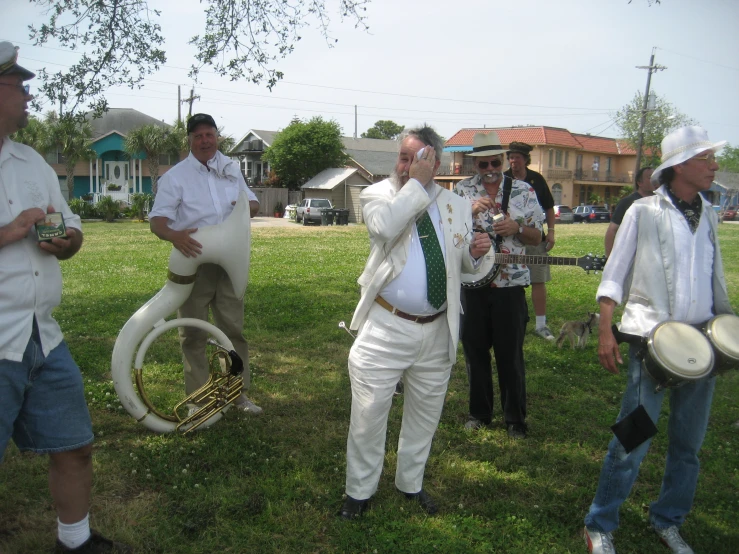 several guys on a grass covered field with two small ss instruments