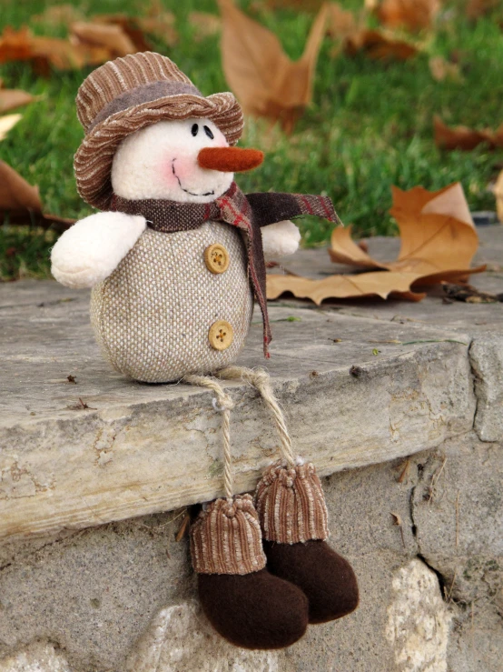 a stuffed snowman is wearing boots and a hat