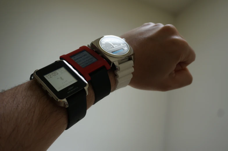 a hand is holding a smart watch in it's wrist