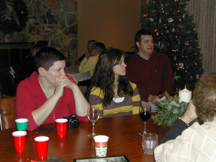 a group of young people at a table with drinks