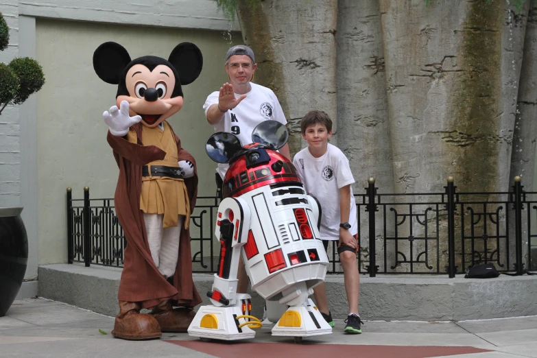 the star wars character and his son pose for a po with a toy figure