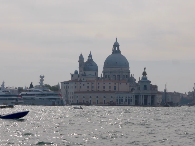 several boats in the water near some buildings