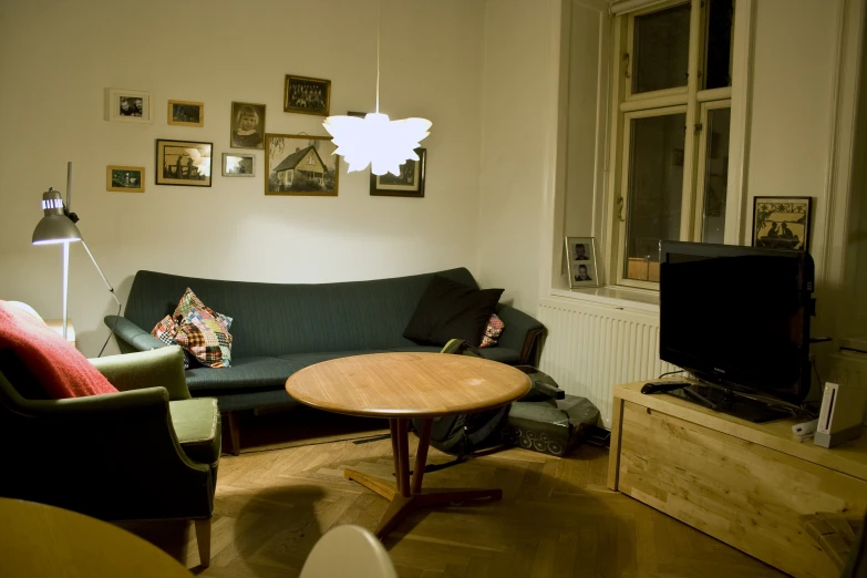 a small living room with furniture and pictures on the wall