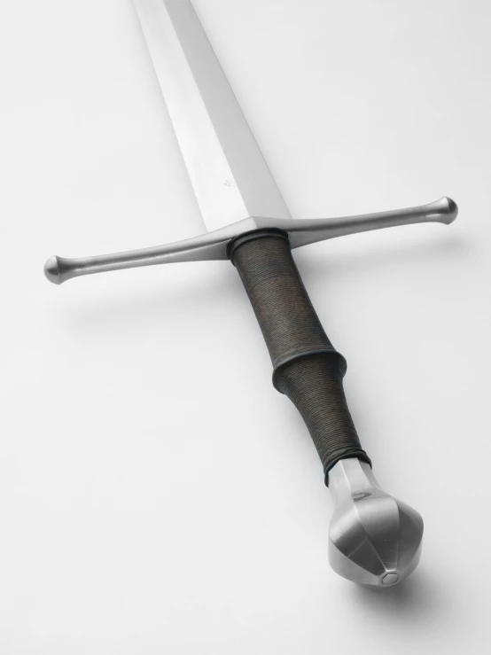 a large knife laying on top of a piece of material