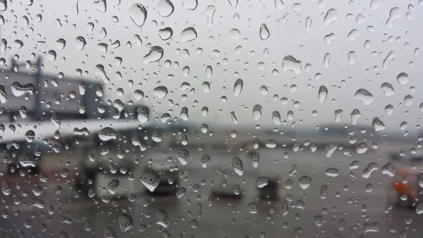 a rain soaked window on an airplane