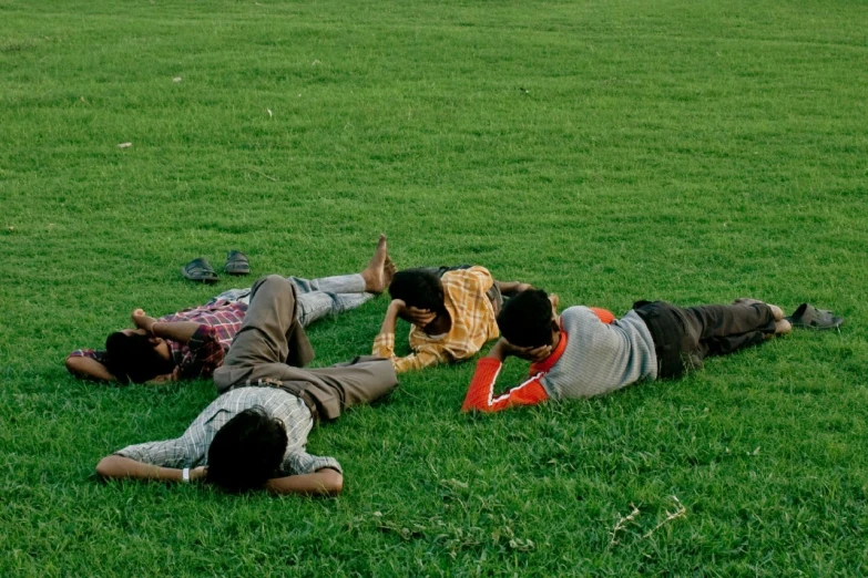 three men laying on the ground together