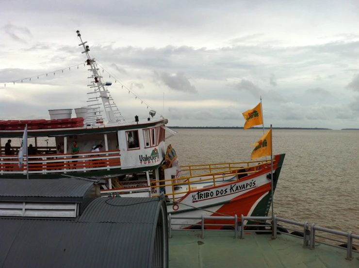 a boat with red, white and green paint is docked