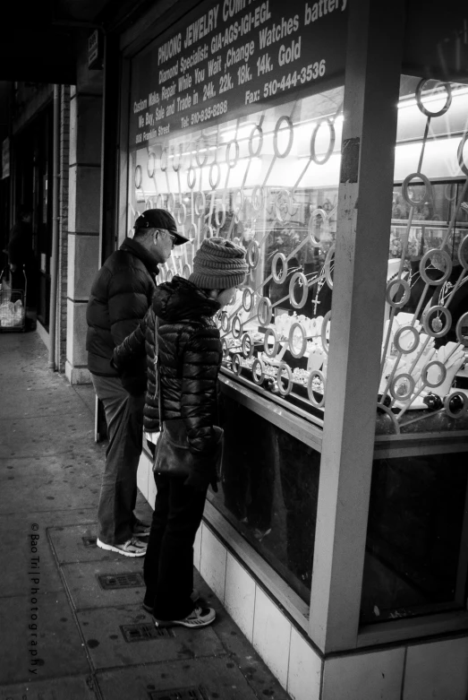 a group of people looking in the glass display window