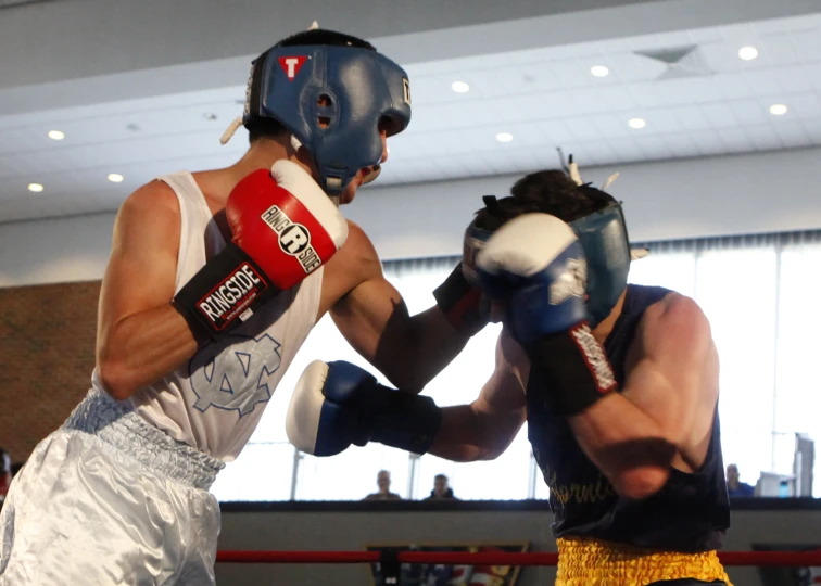 a man wearing boxing gloves and shorts hitting a boxer with their gloves