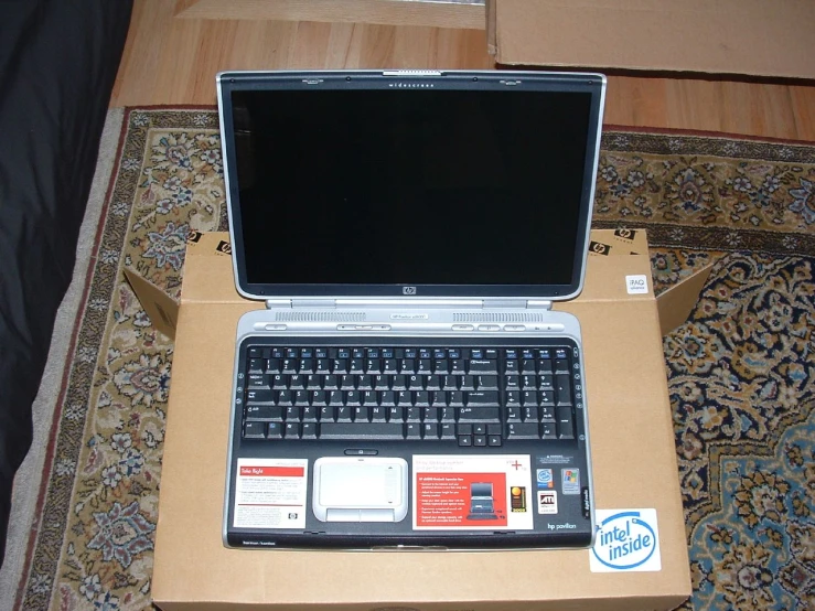 a laptop computer sitting on top of a box