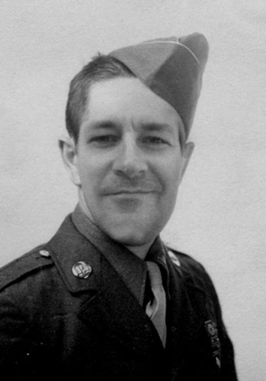 a man in a military uniform smiles for the camera