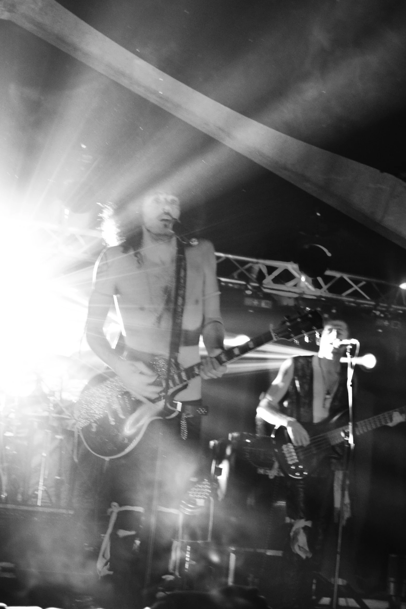 a man with a guitar on stage in front of people