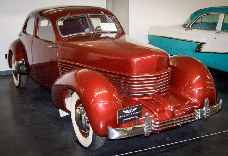 an antique car that is on display on the wall