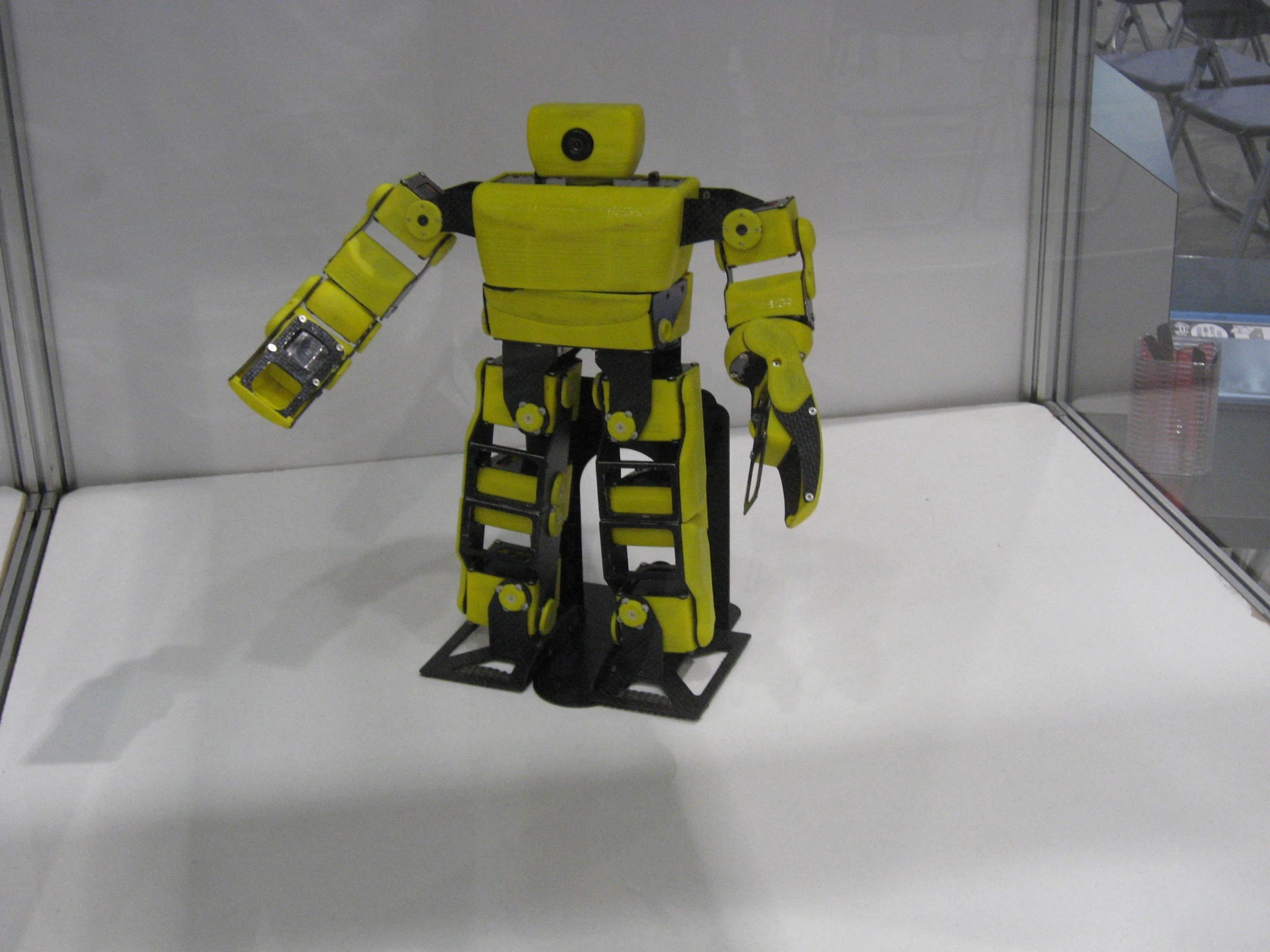 a large yellow robot is on display inside