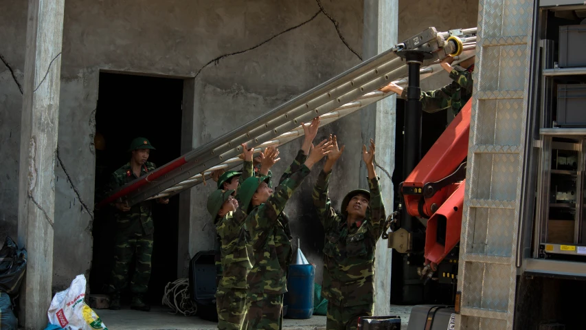 a bunch of men holding up some equipment