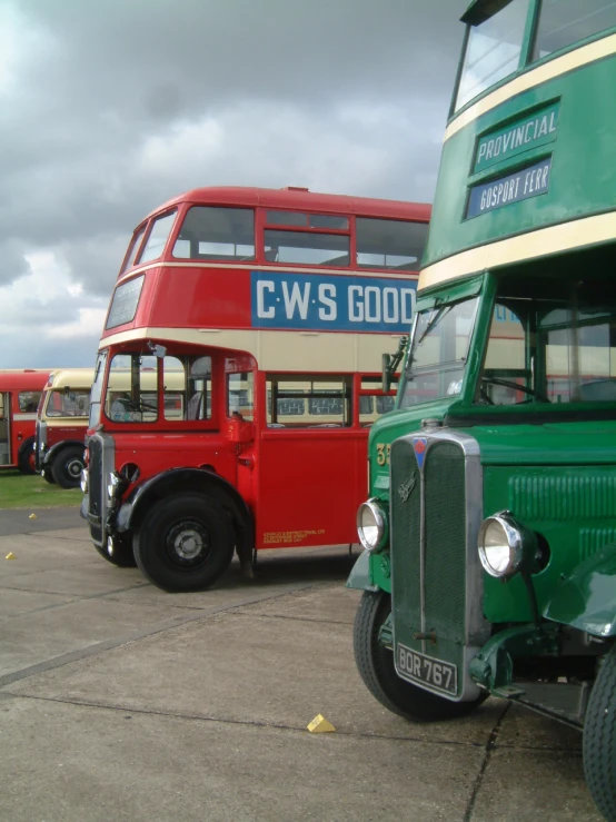 a couple of double decker buses on a parking lot